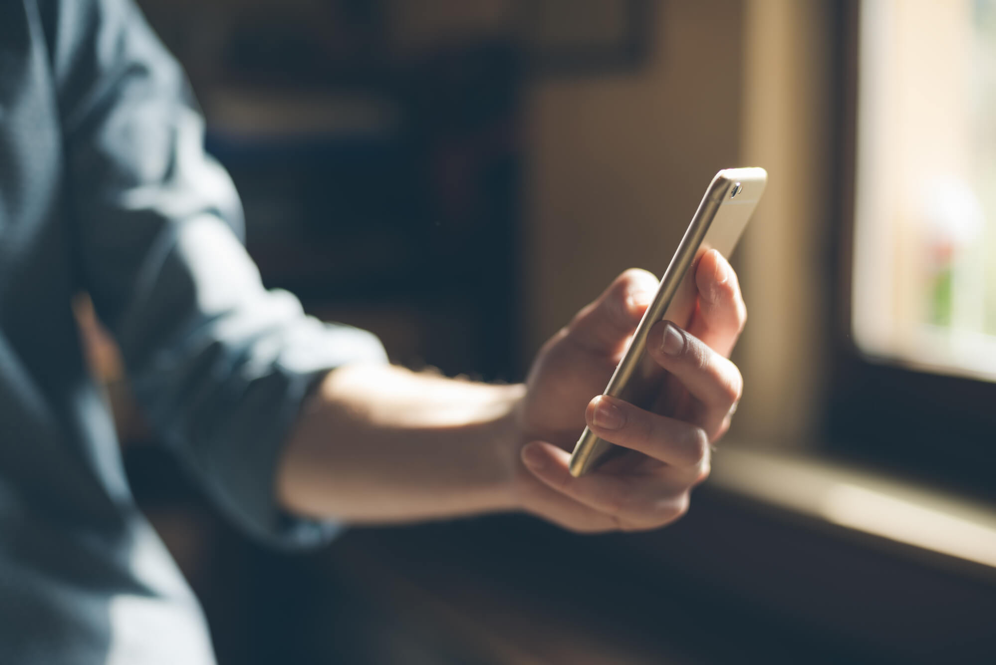 Young man using a mobile phone to text