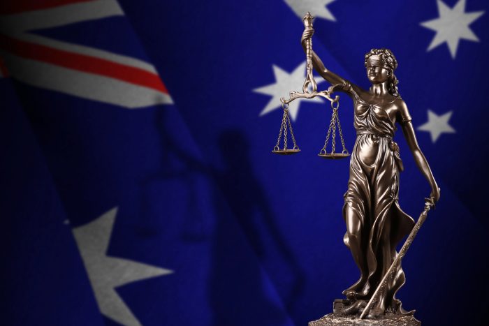 Australia flag with statue of lady justice and judicial scales