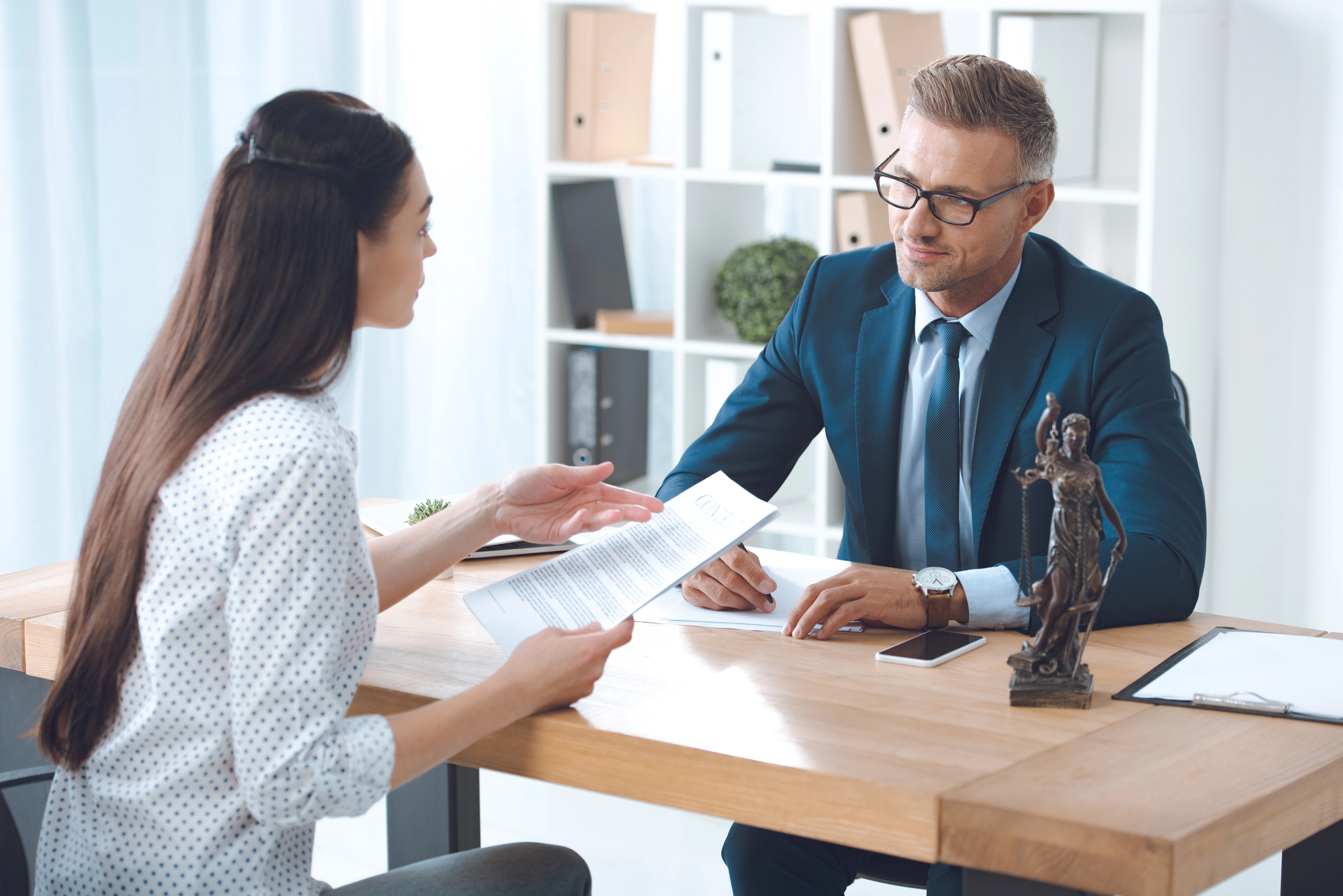 Lawyer and client looking at each other while discussing