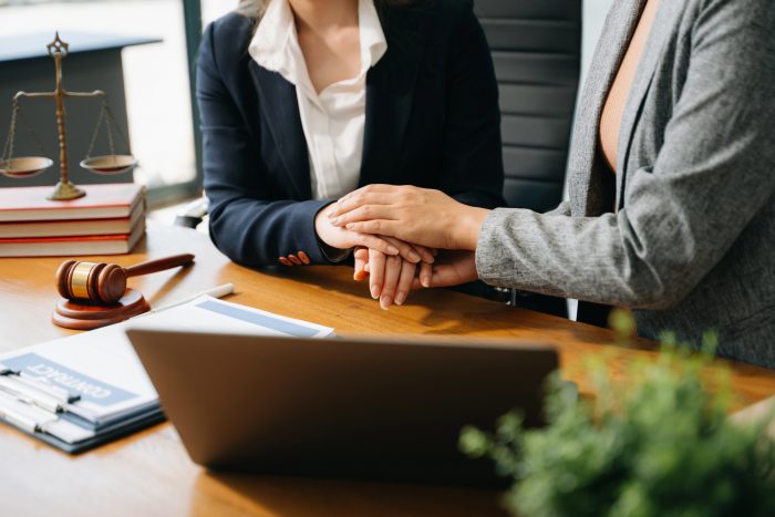 Business people compassionately holding hands and discussing